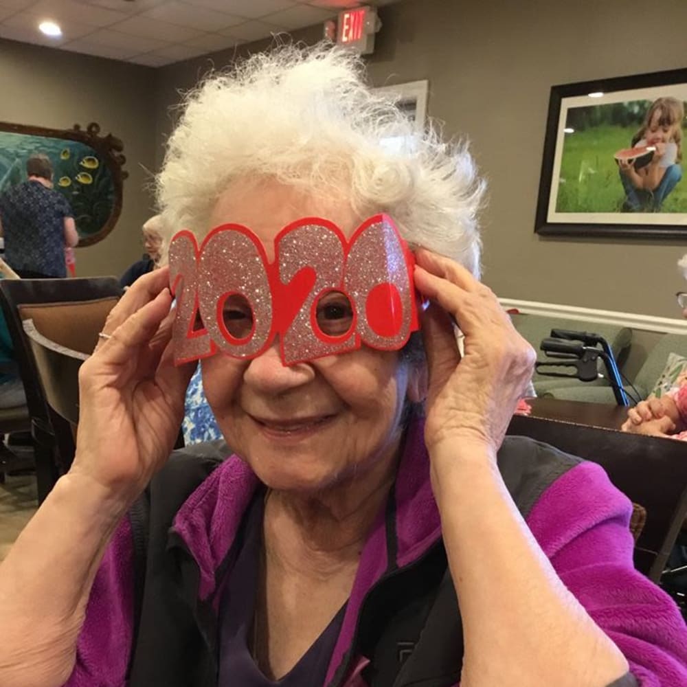 A resident having fun celebrating the New Year at Inspired Living Hidden Lakes in Bradenton, Florida.