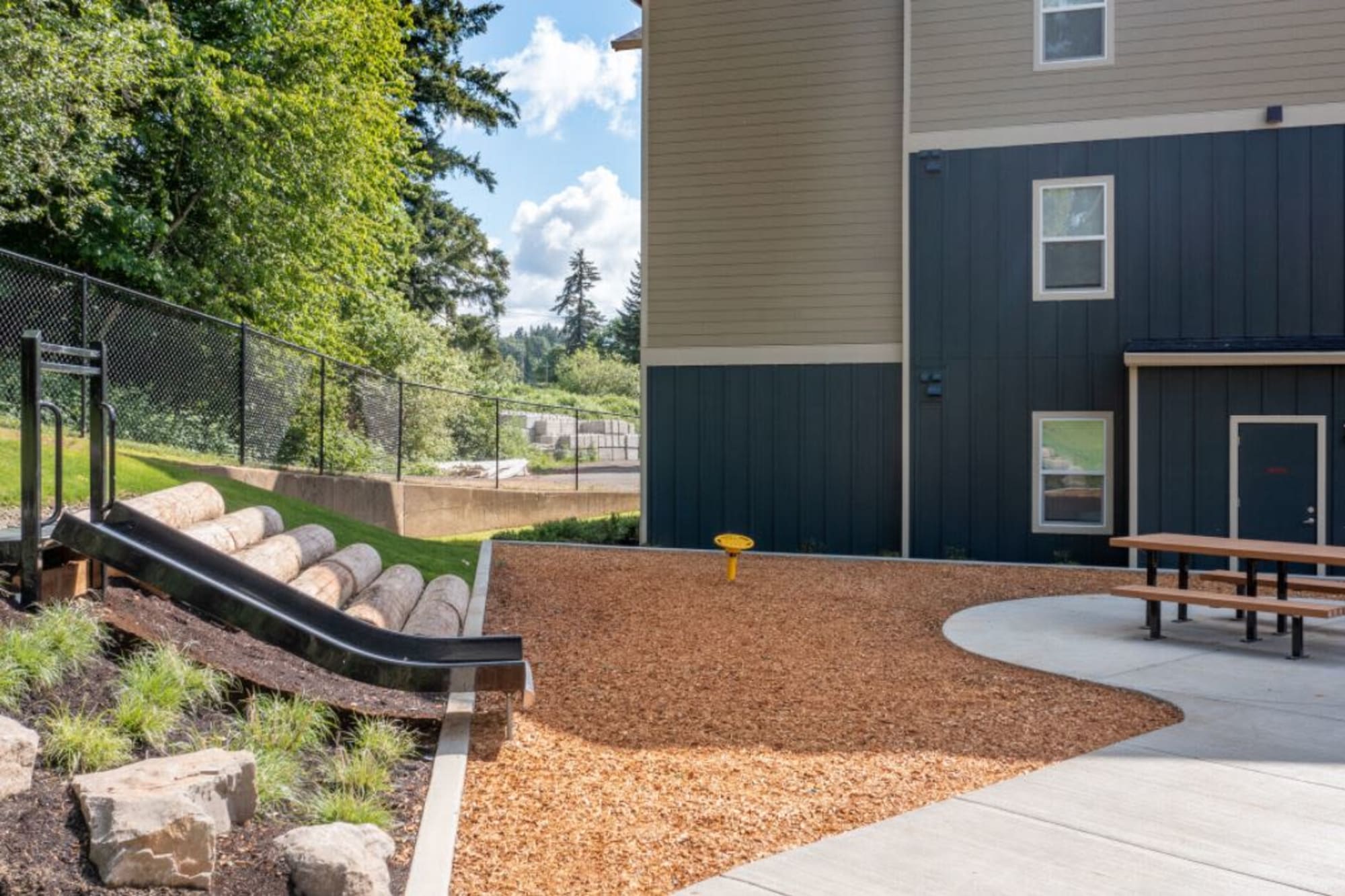 A slide and picnic table in a communal outdoors area at Haven Hills in Vancouver, Washington