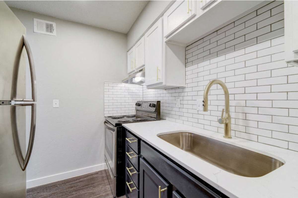 Modern kitchen with sleek cabinetry and stainless steel appliances at Sangria Park in Austin, Texas.