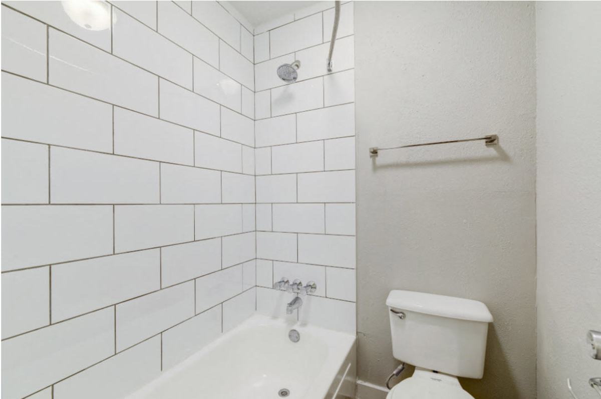Sleek bathroom featuring contemporary subway tile and a relaxing bathtub at Sangria Park in Austin, Texas.