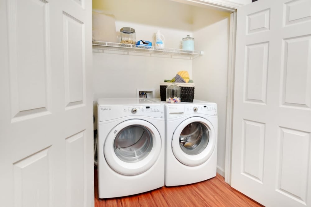 In-home washer and dryer with shelving at The Parc at Greenwood Village in Greenwood Village, Colorado