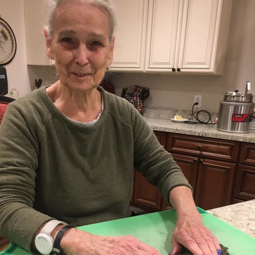A resident cooking at Inspired Living Lewisville in Lewisville, Texas.