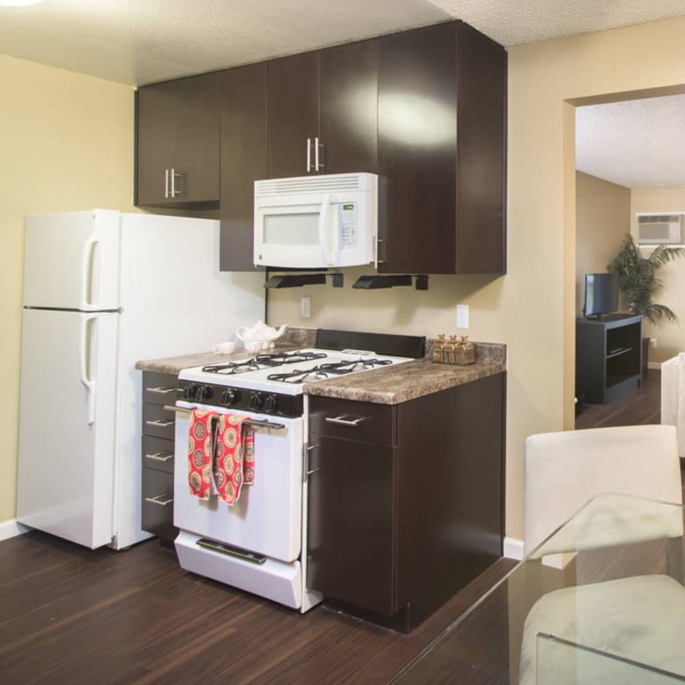 Refrigerator and oven in the kitchen at Village Green Apartments in San Jose, California