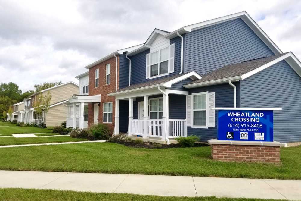 Colorful apartment community with well-maintained lawns and welcoming porches at Wheatland Crossing II in Columbus, Ohio