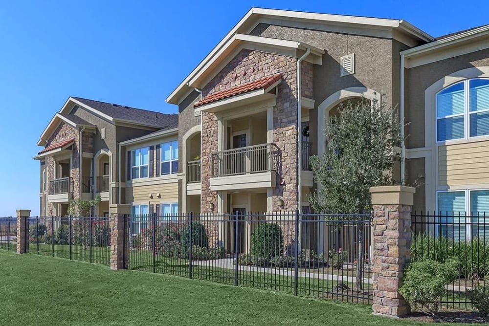 Modern apartment building with gated entrance at Villas On Independence in Port Lavaca, Texas