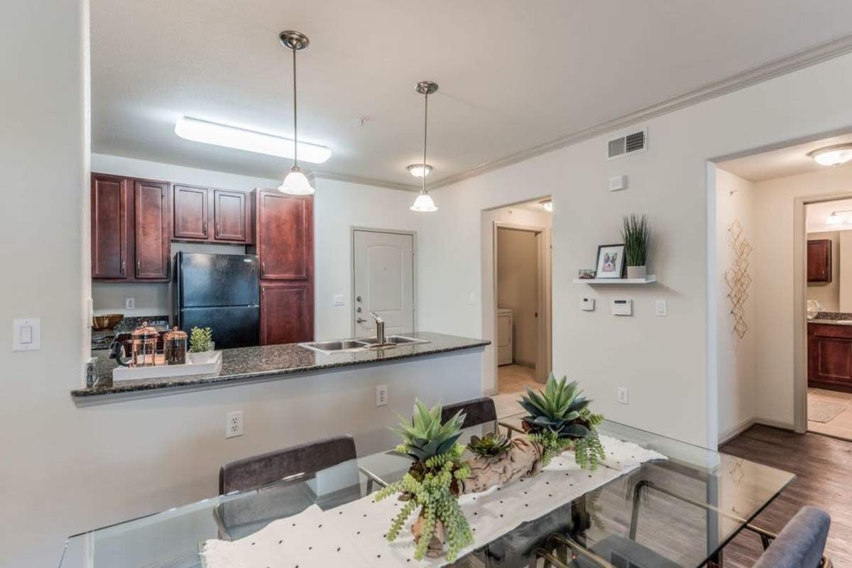 Dining area with view of open kitchen at Villas At Bunker Hill, Houston, Texas