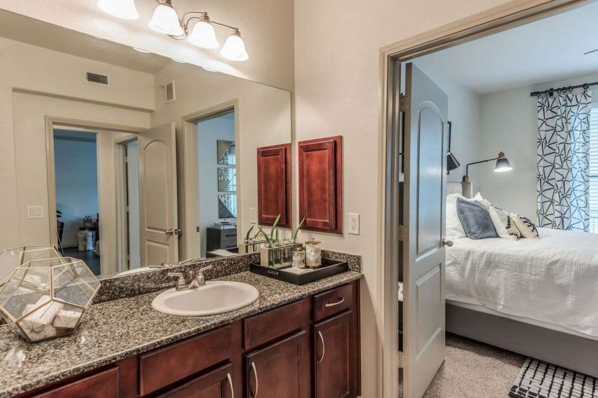 Washroom with large mirror with view of bedroom at Villas At Bunker Hill in Houston, Texas