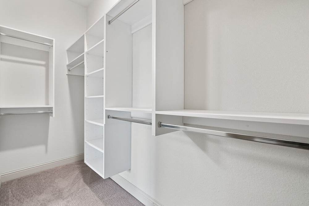 Walk-in closet with racks at Domain Memorial in Houston, Texas
