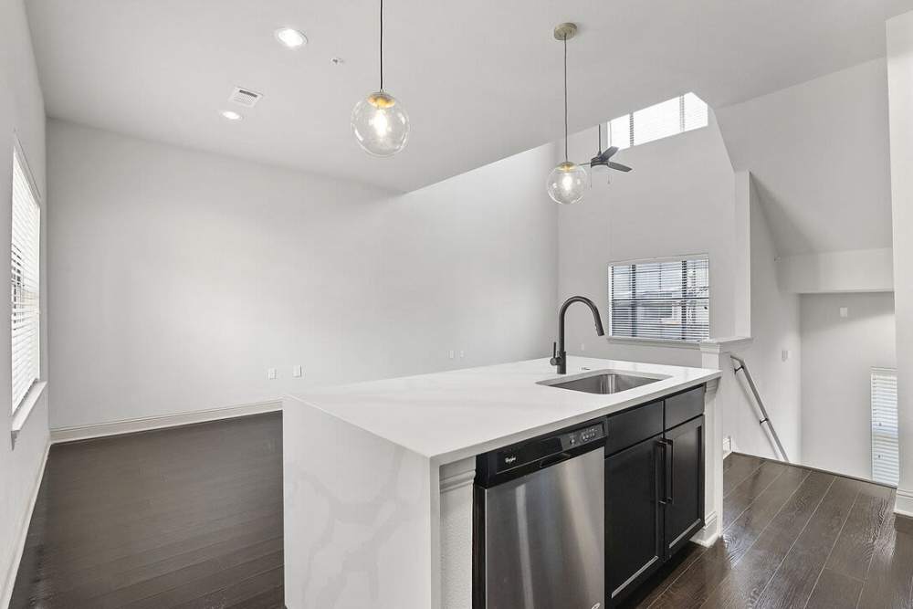 Kitchen with island countertop and dishwasher unfurnished living room at Domain Memorial in Houston, Texas
