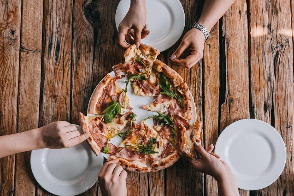 Resident having pizza at Renwood Apartments in Boston, Massachusetts