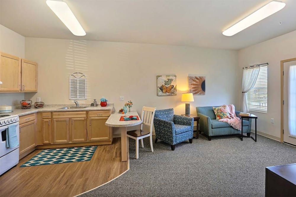 Resident living room with large windows at Milestone Senior Living Stoughton in Stoughton, Wisconsin.