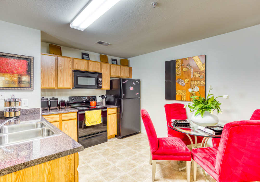 Stainless steel refrigerator, drawer microwave, and sink with and granite countertops at Eagle Point Village in Fayetteville, North Carolina  