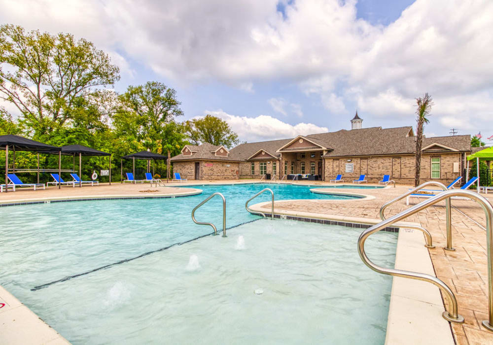 Large spa connecting into large pool with view of covered lounge chairs and clubhouse at Glass Creek in Mt Juliet, Tennessee