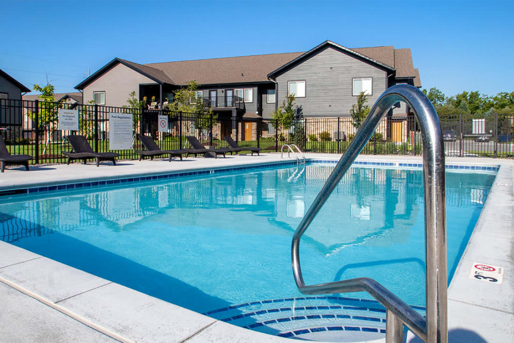 Exterior view of a swimming pool and house at Ravello 192 in Elkhorn, Nebraska