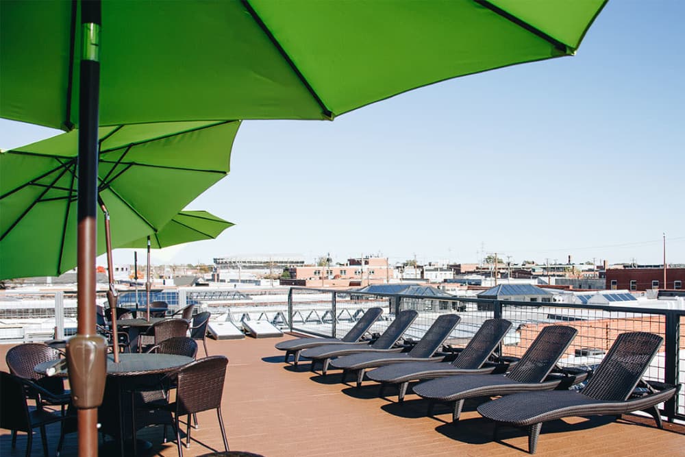 Rooftop lounge with green umbrellas and seating at Courtyard Lofts at Scott’s Addition in Richmond, Virginia