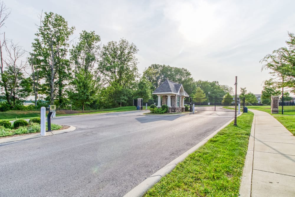 Gated entrance with lots of trees, grass, and walking area at Everwood at The Avenue in Murfreesboro, Tennessee