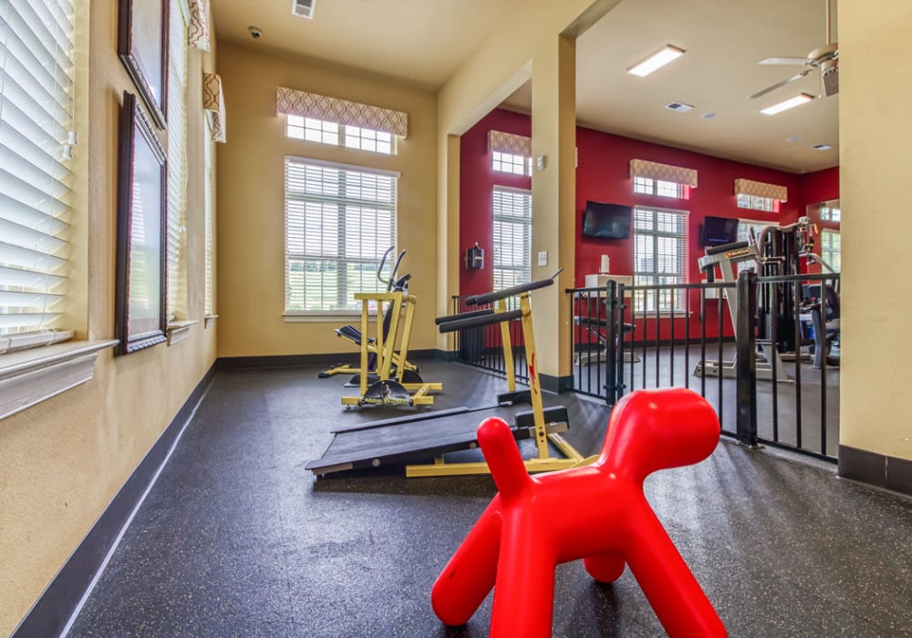 Indoor pet play area with puppy treadmills and a red dog statue at Glass Creek in Mt Juliet, Tennessee