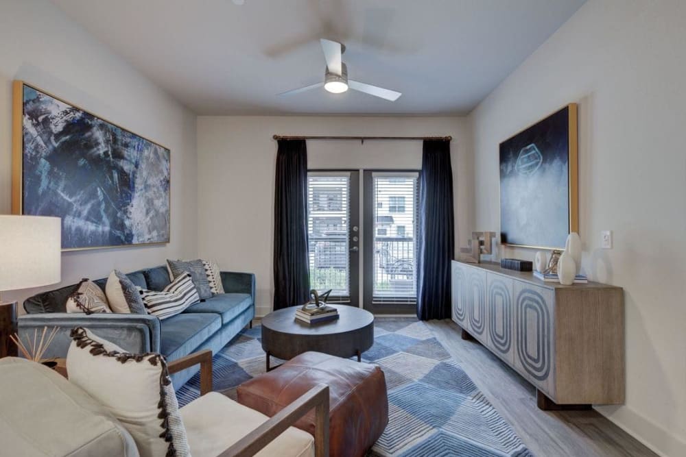 Model living room with door to private balcony at Palmetto Pointe in San Antonio, Texas