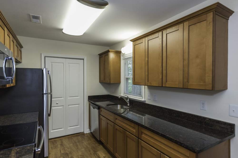 Quartz countertops and wooden cabinets at Fox Chase Apartments in Fredericksburg, Virginia