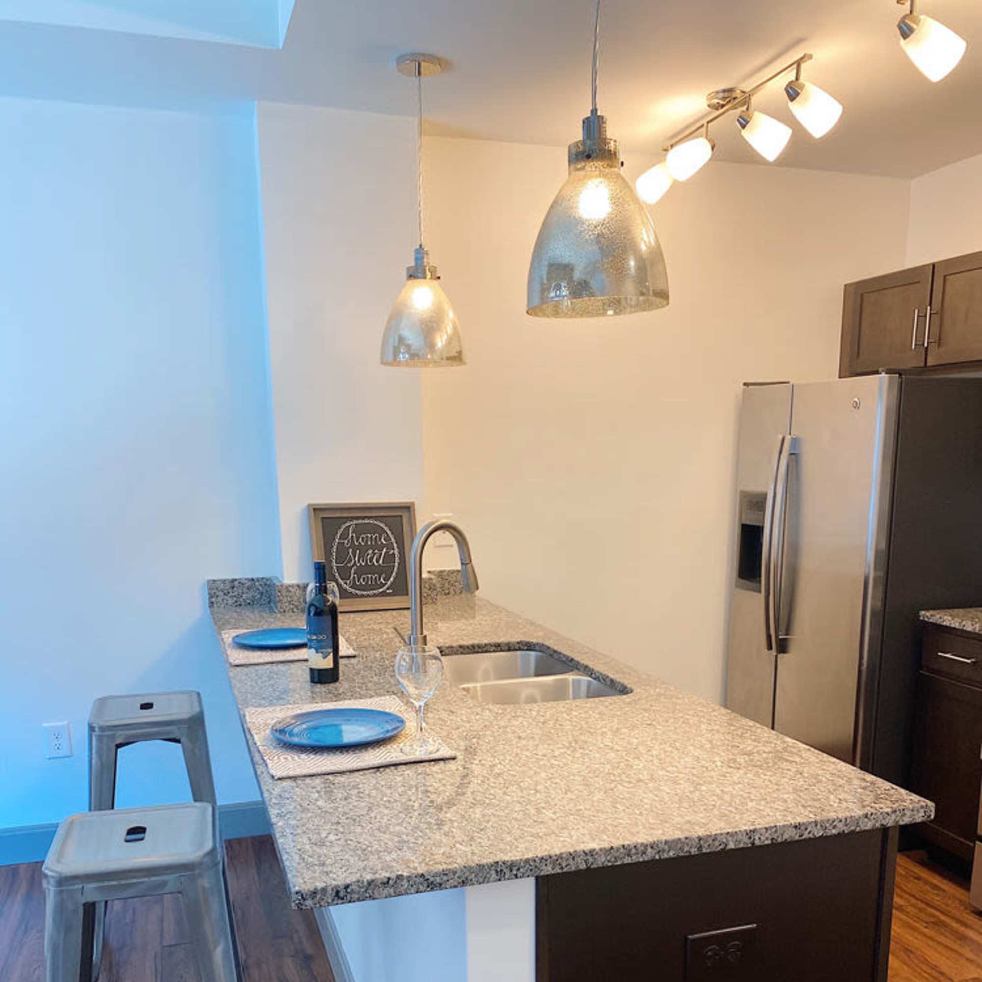 Kitchen with stainless-steel appliances, granite countertop and barstool at The Atlas in Columbus, Ohio