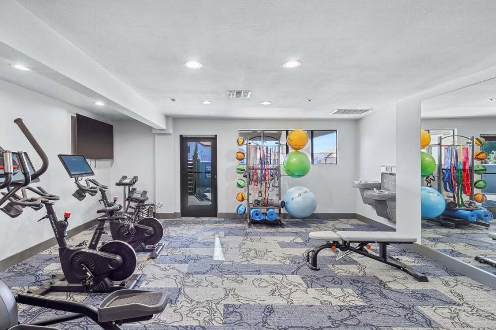 Fitness center with carpet flooring at Clifton on 7th in Phoenix. AZ