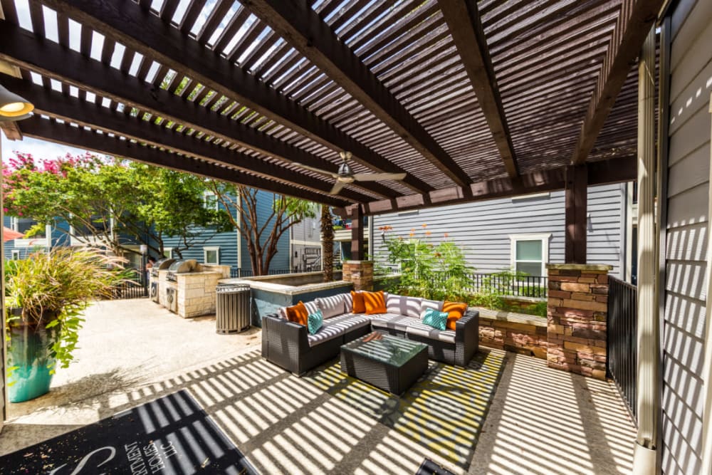 BBQ and gazebo area with cushioned couches at Austin Midtown in Austin, Texas