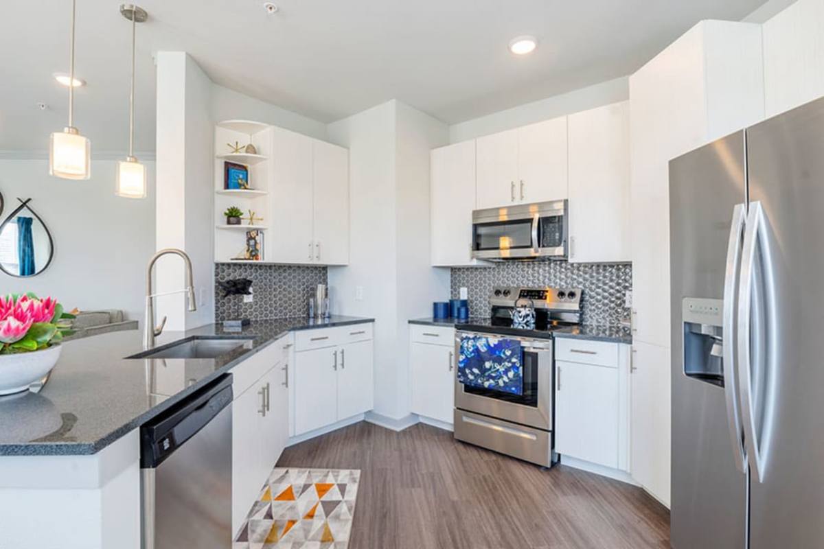 Kitchen with stainless-steel appliances at Caliber at Flatirons in Broomfield, Colorado