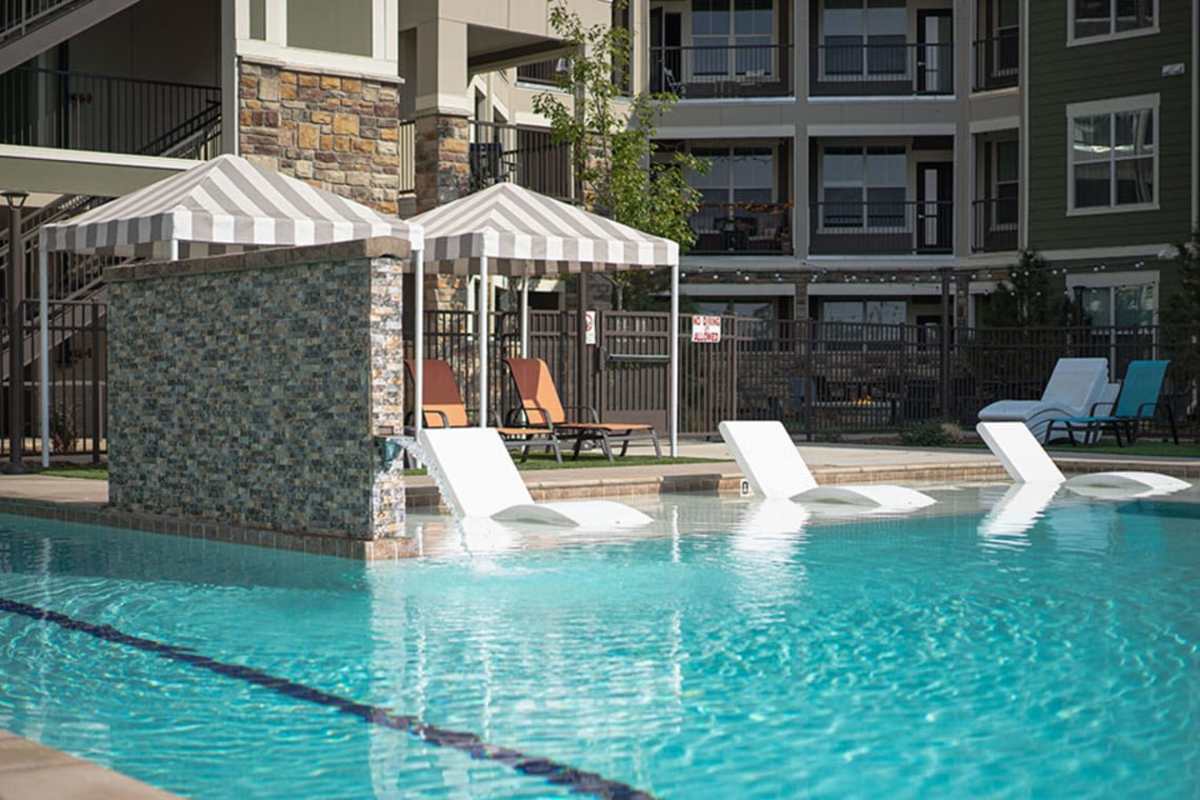 Lounge chairs in the pool at Caliber at Flatirons in Broomfield, Colorado