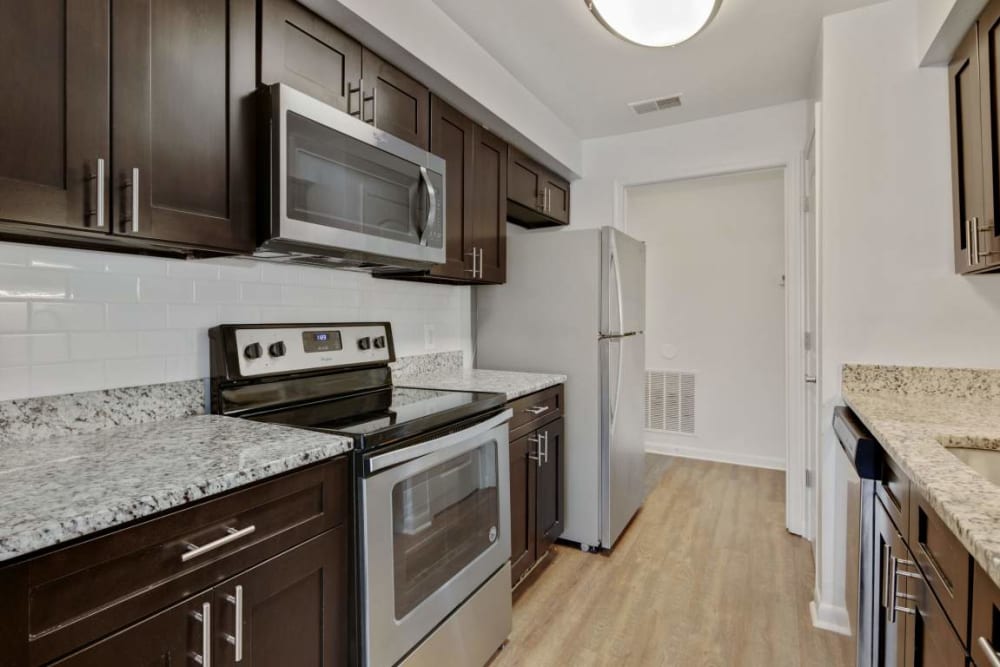 Apartment kitchen with granite countertops at Annen Woods Apartments in Pikesville, Maryland