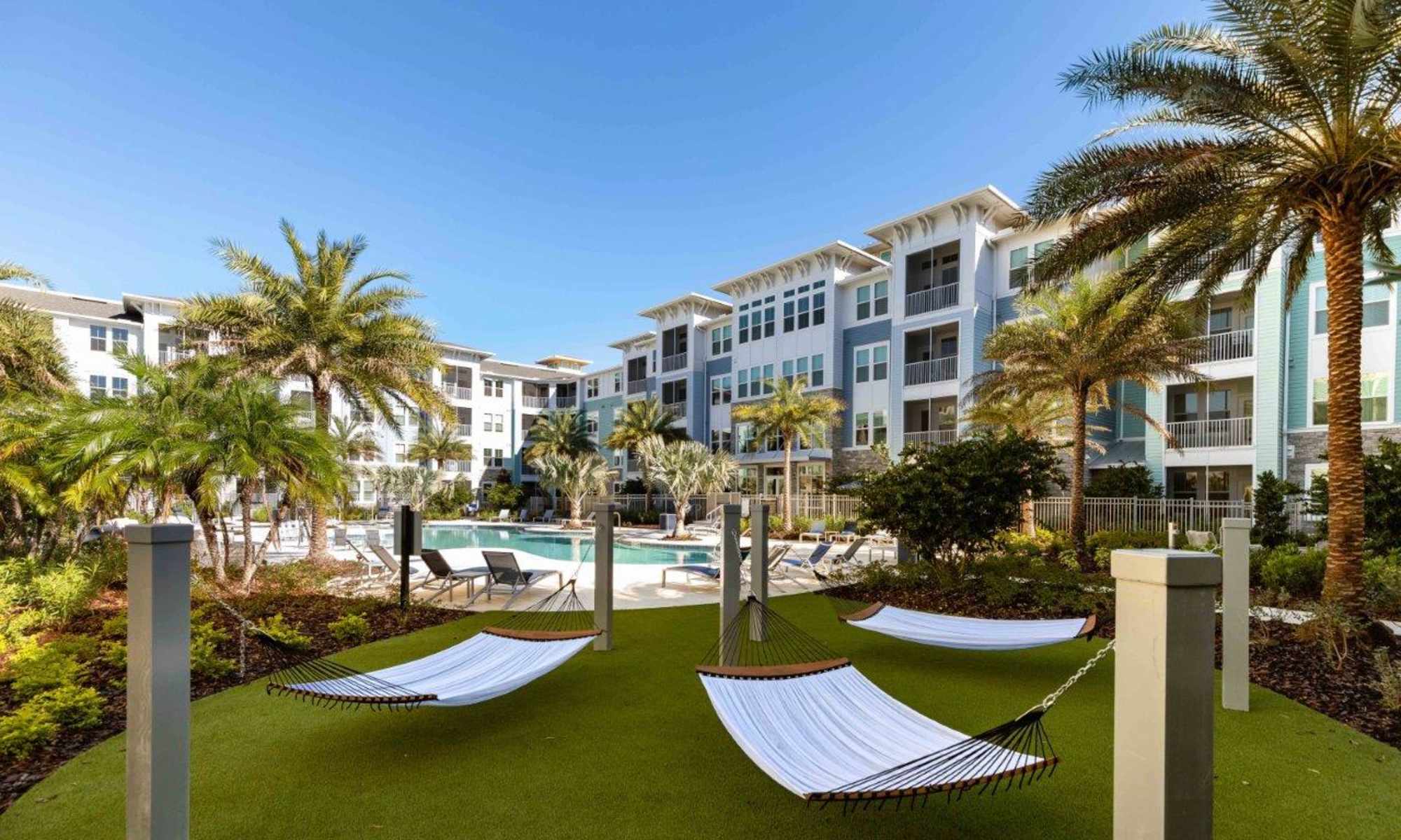 Lounges outside by the pool at The Addison Skyway Marina in St. Petersburg, Florida