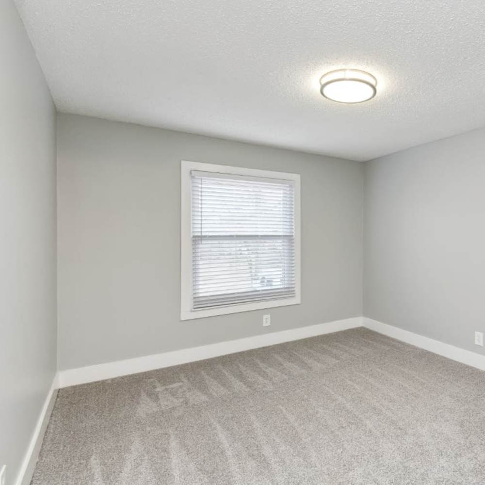 Spacious bedroom with a large window at Meadow Glen Apartments in Springfield, Tennessee
