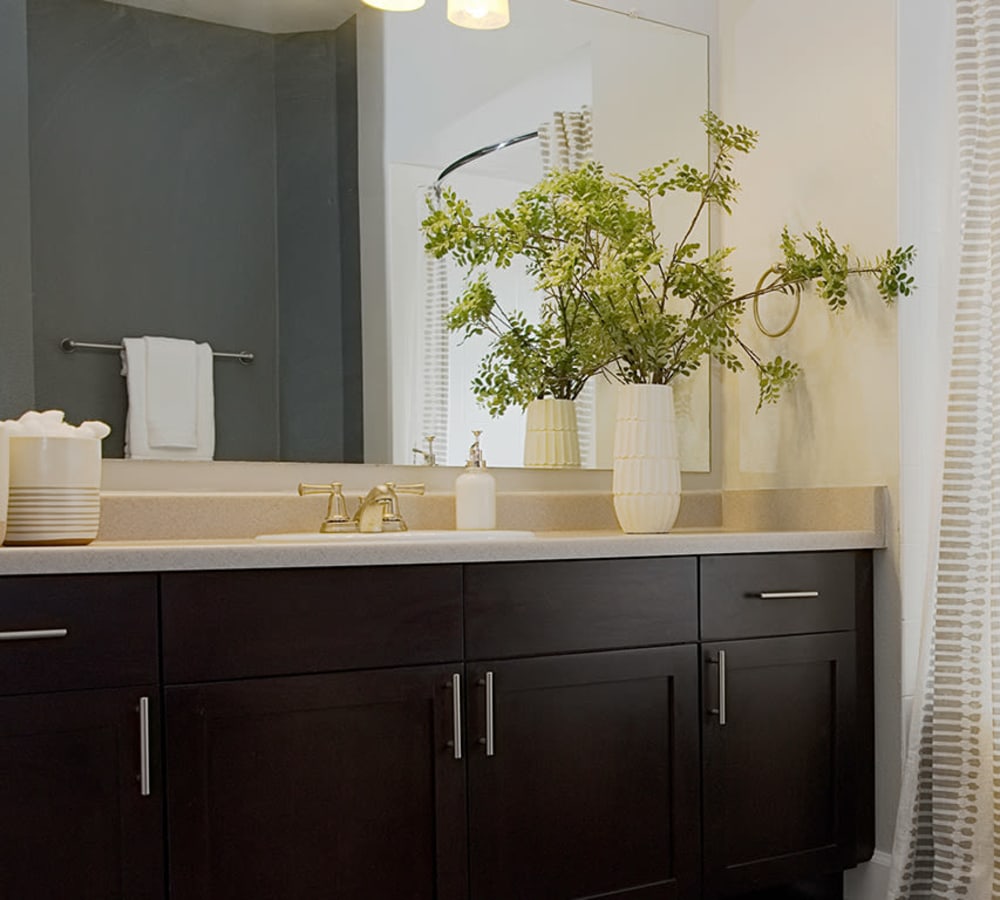 Model bathroom with granite countertops at Isabella Apartment Homes in Greenwood Village, Colorado