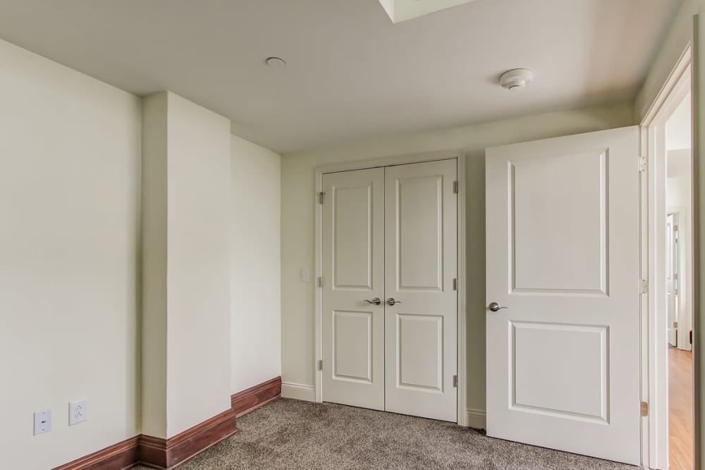 Empty room with two white doors leading to other spaces at 43 Town Square in Lima, Ohio