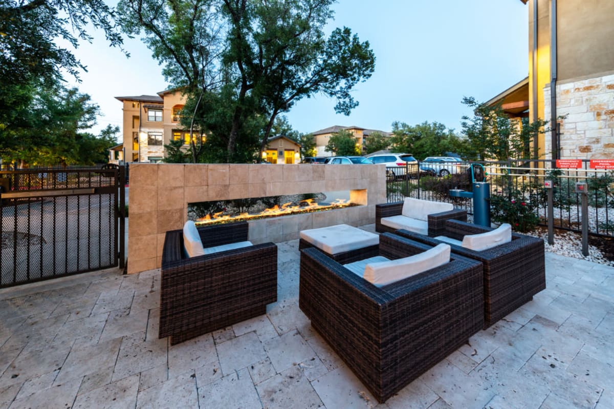 Outdoor sitting area next to standing fireplace at Austin, Texas from Marquis at Barton Trails