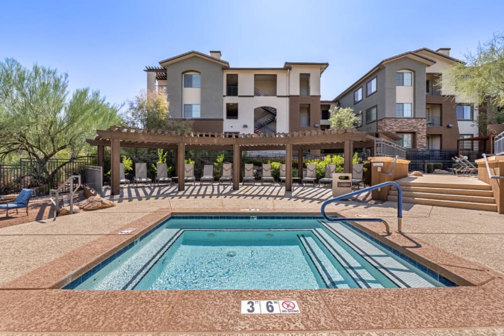 Hot tub with partially shaded lounge chair area at Marquis at Sonoran Preserve in Phoenix, Arizona