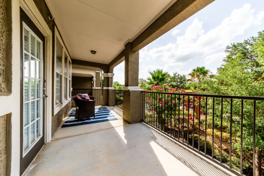 Spacious private balcony overlooking tree-filled grounds at Marquis at Stone Oak in San Antonio, Texas