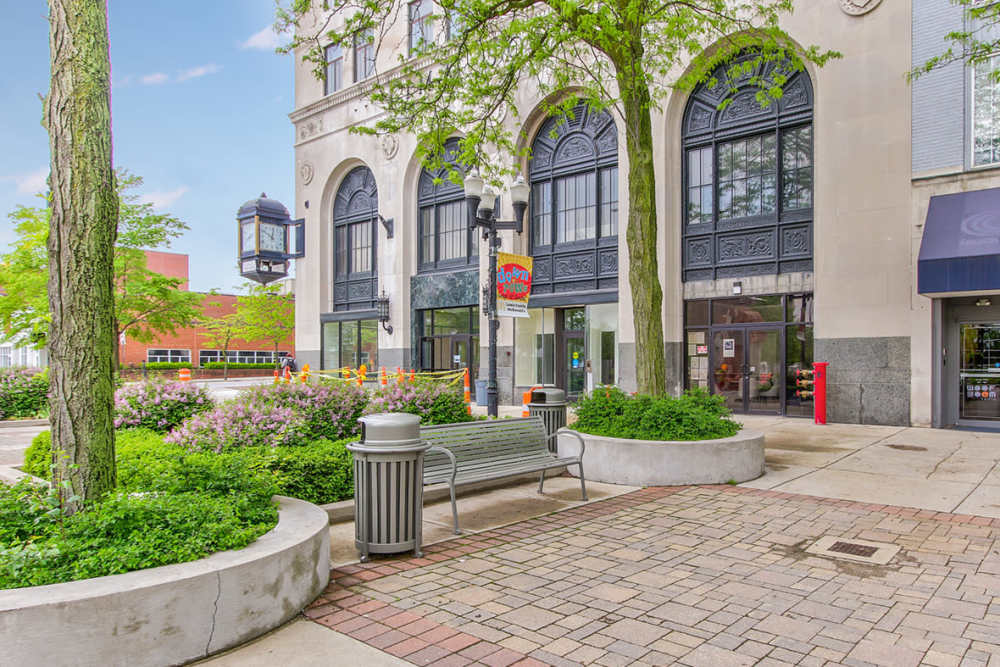 Lush landscaping with benches and decorative clock at 43 Town Square in Lima, Ohio