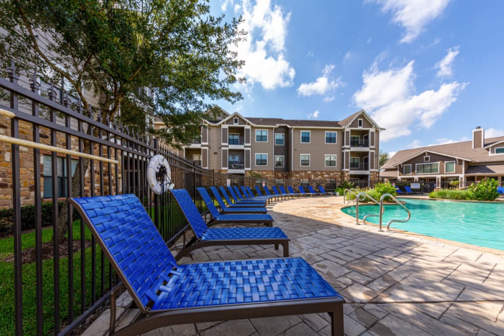 Outdoor poolside lounge area at Marquis at Katy in Katy, Texas