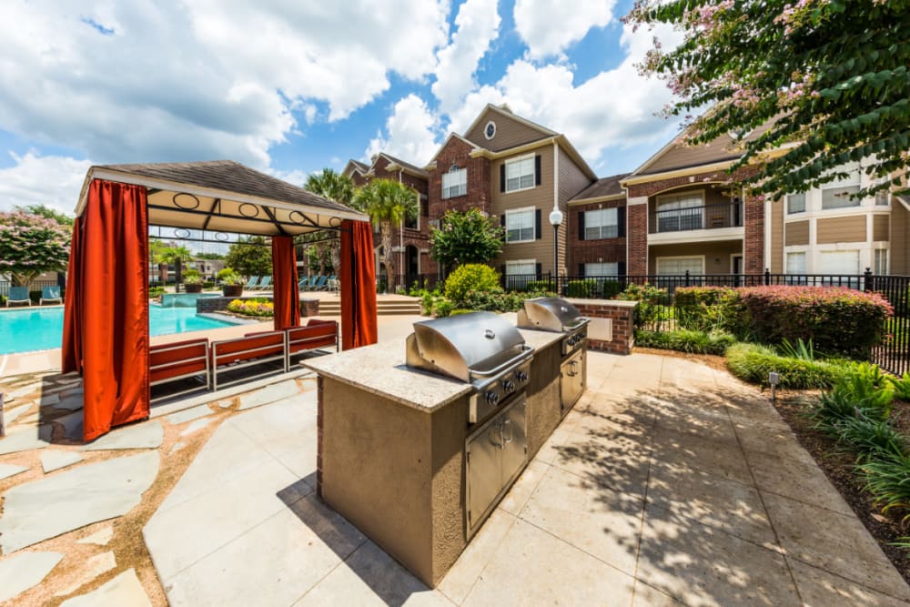 Stainless steel BBQs behind gazebos at Marquis on Park Row in Houston, Texas