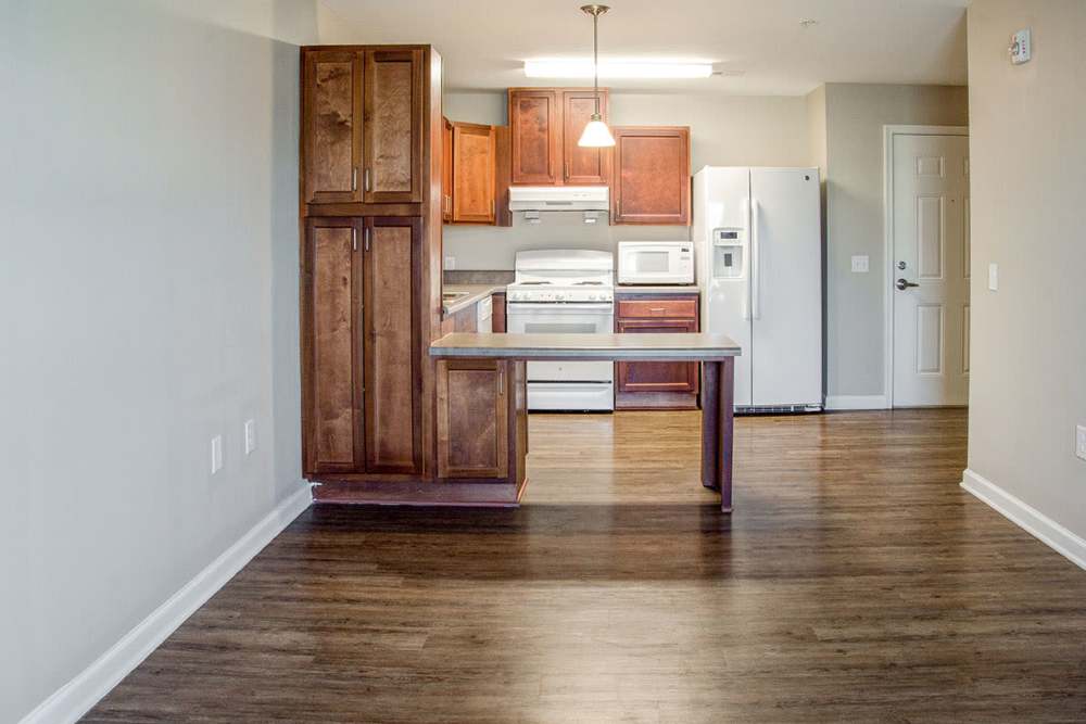 Modern kitchen with wooden cabinets at Brennan Pointe I in Newport News, Virginia