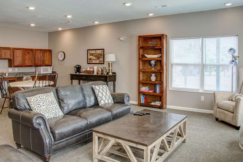 Community room with a comfortable couch at Brennan Pointe I in Newport News, Virginia
