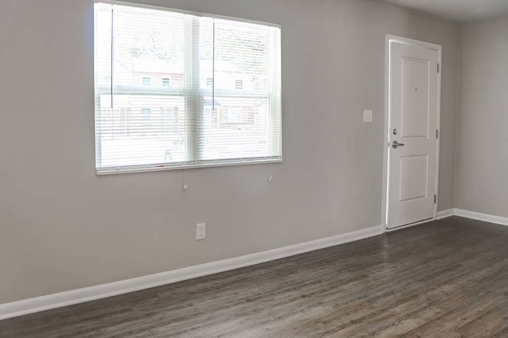 Model apartment home with wood style flooring at Bell Diamond Manor in Norfolk, Virginia