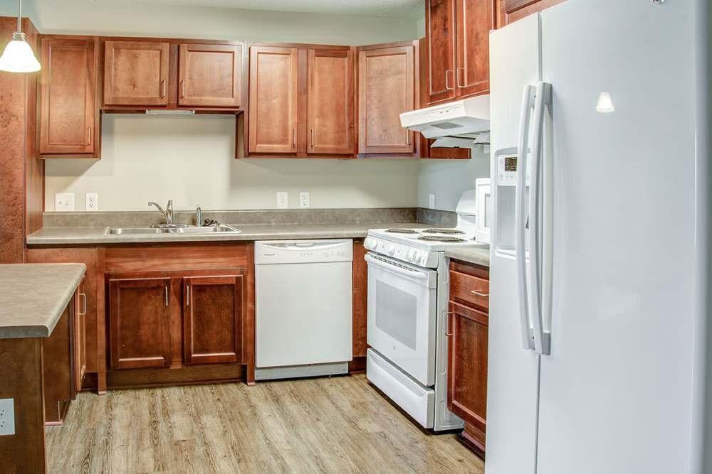 Kitchen with a refrigerator and a microwave at Brennan Pointe I in Newport News, Virginia