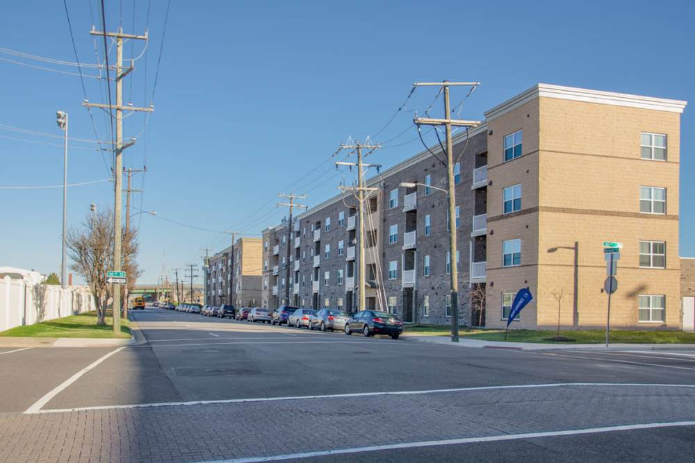Exterior view of the building and multiple cars parked in front of the building at Brennan Pointe I in Newport News, Virginia