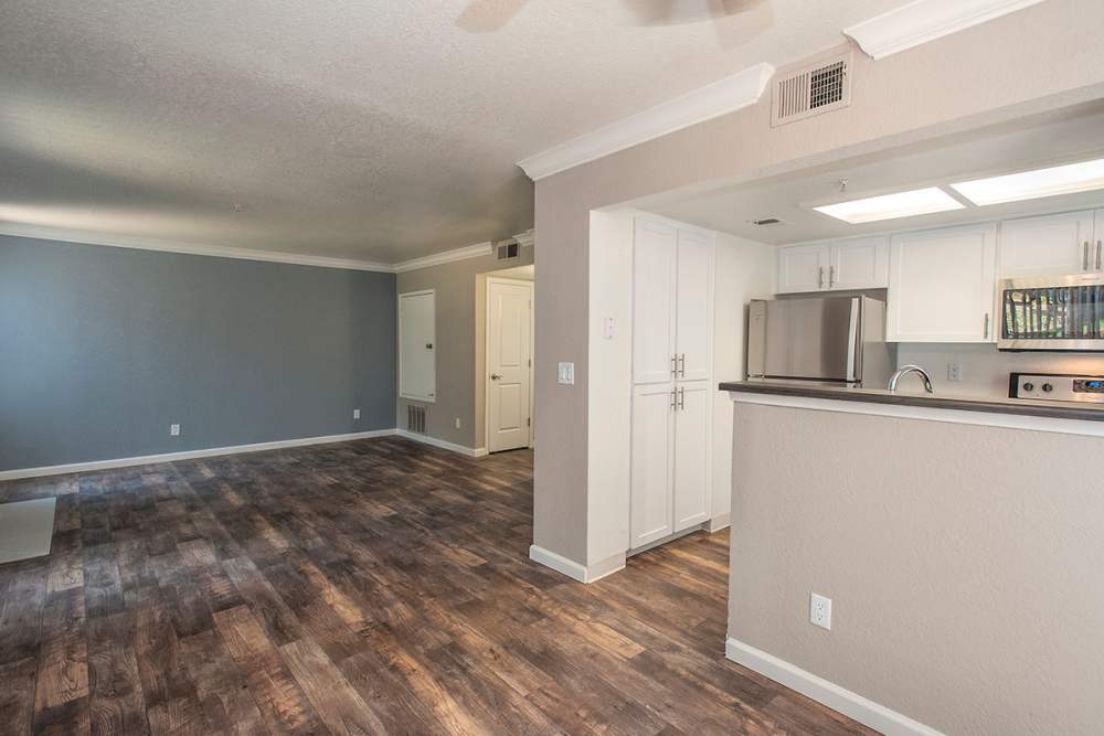 Spacious living area with wood style flooring at Sandpiper Village Apartment Homes in Vacaville, California