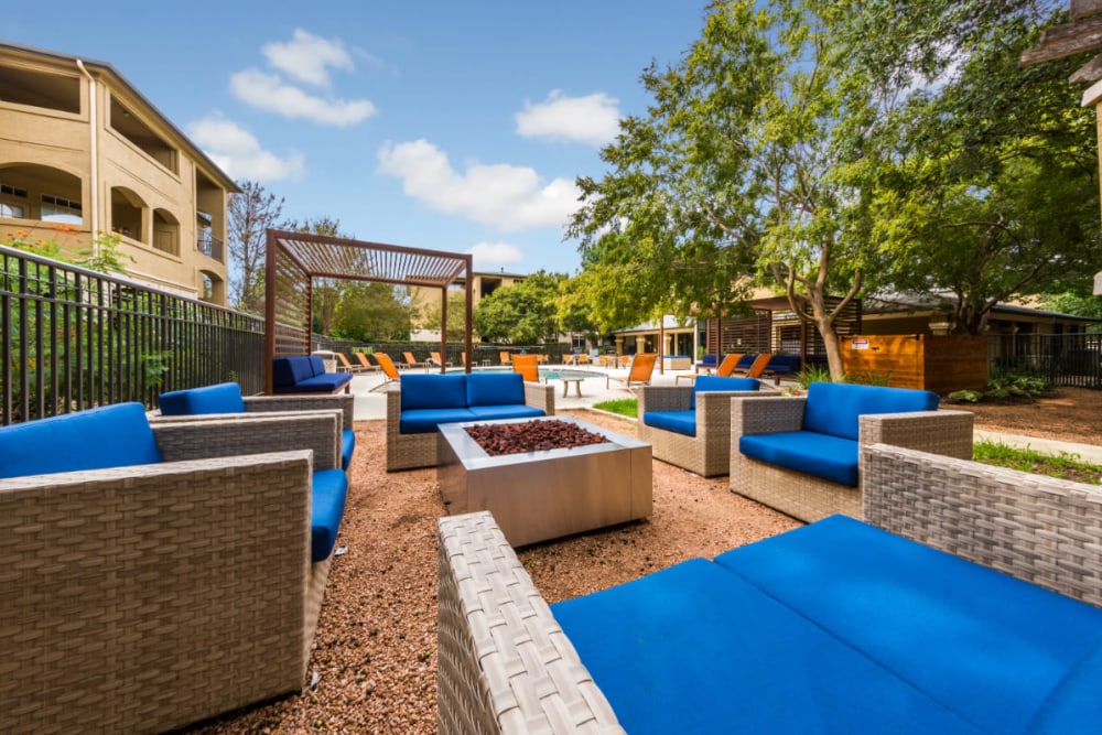 Outdoor cushioned seating with fire pit at Marquis at Barton Trails in Austin, Texas