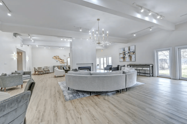 Indoor community seating with wooden flooring and bright lighting at Terraces of Elk Grove in Elk Grove Village, Illinois