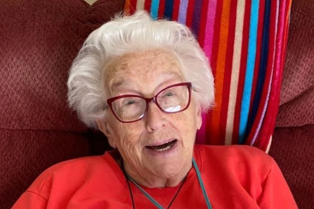 Resident relaxing in a chair at Addington Place of Des Moines in Des Moines, Iowa.