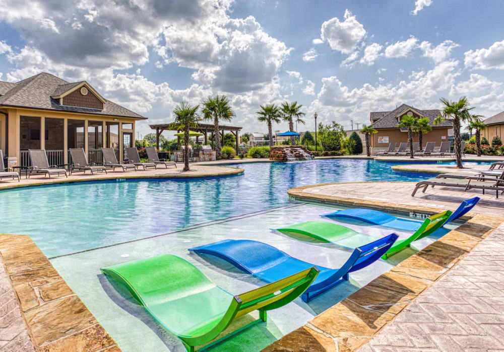 Lounge chairs on pool deck at Arrington Ridge in Round Rock, Texas