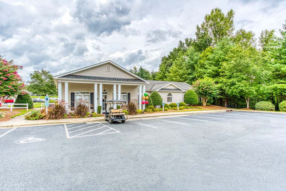 Front office surrounded by green trees and parking lot at Brannigan Village in Winston Salem, North Carolina